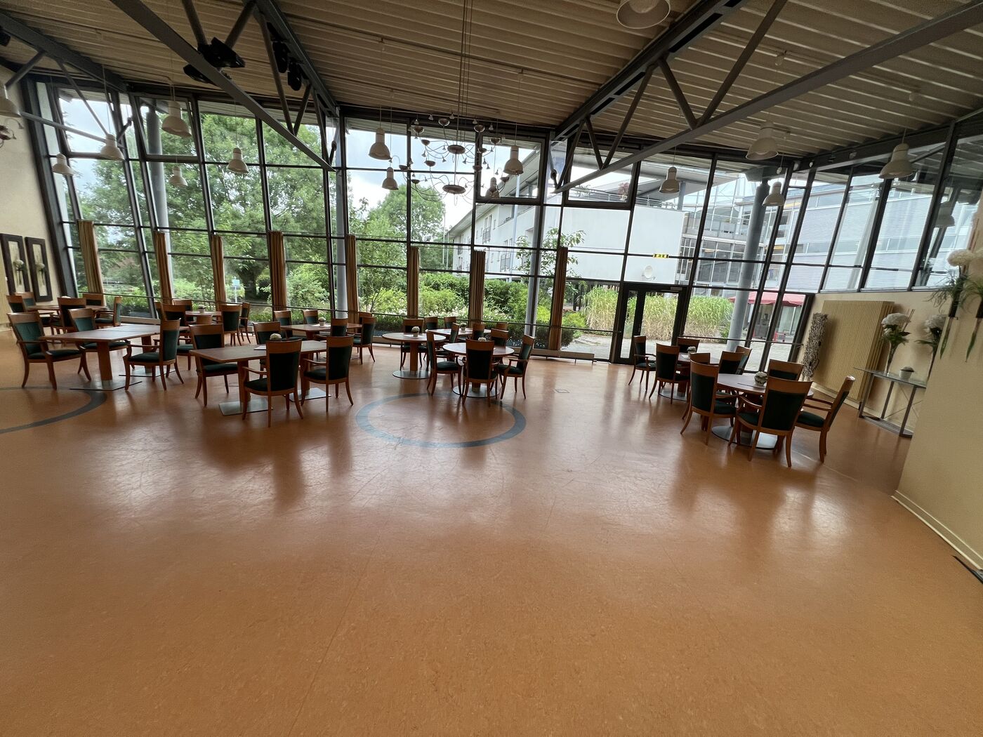 Lichtdurchfluteter Gemeinschaftssaal der Einrichtung am Zehnthof mit großer Glasfassade